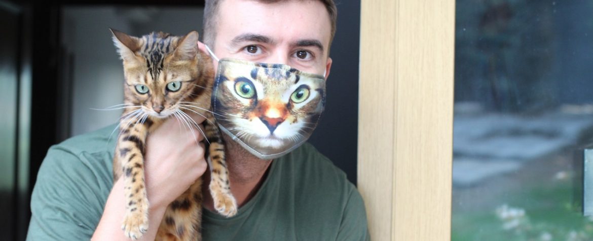 Mężczyzna ma na twarzy maseczkę ochronną z nadrukiem kota